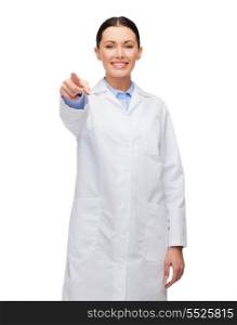 healthcare and medicine concept - smiling female doctor pointing at you