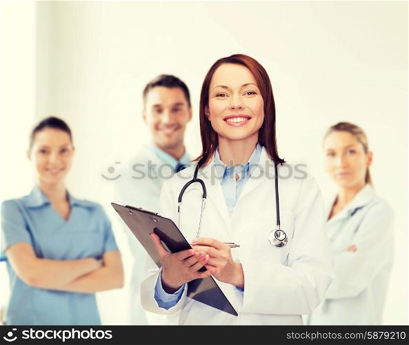 healthcare and medicine concept - smiling female doctor with clipboard and stethoscope. smiling female doctor with clipboard