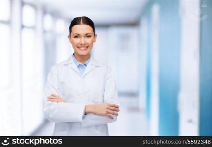 healthcare and medicine concept - smiling female doctor with crossed arms at hospital