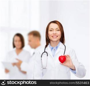 healthcare and medicine concept - smiling female doctor with heart and stethoscope