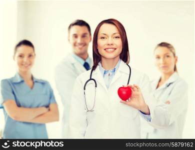 healthcare and medicine concept - smiling female doctor with heart and stethoscope. smiling female doctor with heart and stethoscope