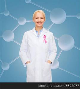 healthcare and medicine concept - smiling female doctor with pink cancer awareness ribbon over molecular background