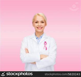 healthcare and medicine concept - smiling female doctor with pink cancer awareness ribbon over pink background