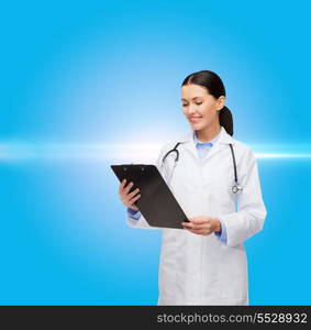 healthcare and medicine concept - smiling female doctor with stethoscope and clipboard