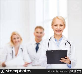 healthcare and medicine concept - smiling female doctor with stethoscope and clipboard