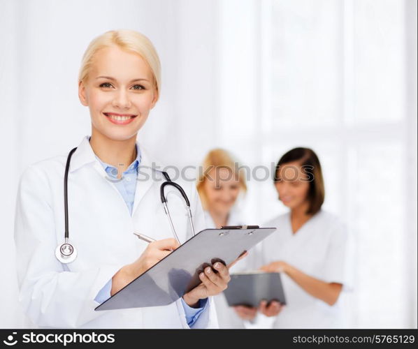 healthcare and medicine concept - smiling female doctor with stethoscope and clipboard