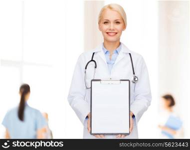 healthcare and medicine concept - smiling female doctor with stethoscope and clipboard and blank page