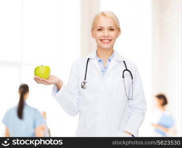 healthcare and medicine concept - smiling female doctor with stethoscope and green apple