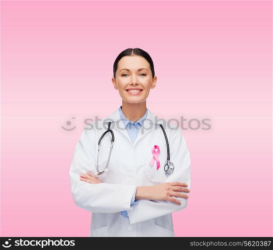healthcare and medicine concept - smiling female doctor with stethoscope and pink cancer awareness ribbon over pink background