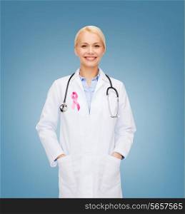 healthcare and medicine concept - smiling female doctor with stethoscope and pink cancer awareness ribbon over blue background