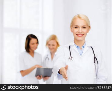 healthcare and medicine concept - smiling female doctor with stethoscope ready to shake hands