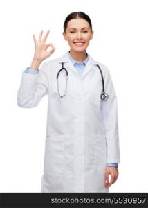 healthcare and medicine concept - smiling female doctor with stethoscope showing okay gesture