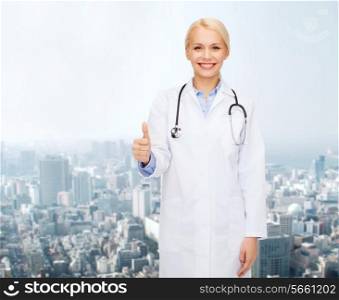 healthcare and medicine concept - smiling female doctor with stethoscope showing thumbs up