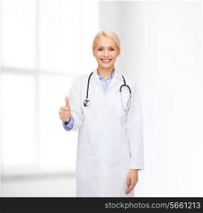 healthcare and medicine concept - smiling female doctor with stethoscope showing thumbs up