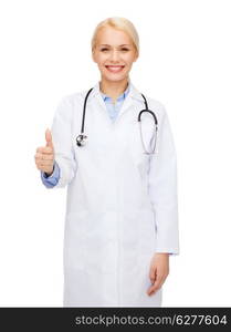 healthcare and medicine concept - smiling female doctor with stethoscope showing thumbs up