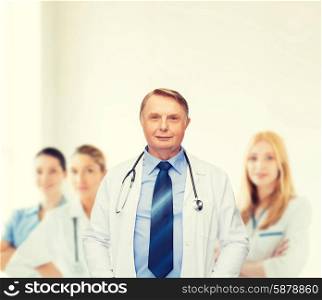 healthcare and medicine concept - smiling standing doctor or professor with stethoscope