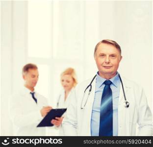 healthcare and medicine concept - smiling standing doctor or professor with stethoscope. smiling doctor or professor with stethoscope