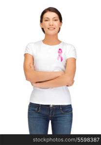 healthcare and medicine concept - smiling woman in blank t-shirt with pink breast cancer awareness ribbon