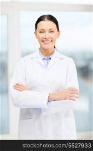 healthcare and medicine concept - smiling young doctor in cabinet