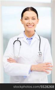 healthcare and medicine concept - smiling young doctor with stethoscope in cabinet