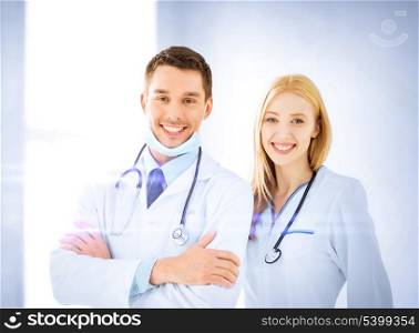 healthcare and medicine concept - two young attractive doctors