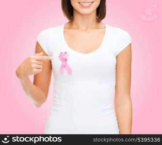 healthcare and medicine concept - woman in blank t-shirt with pink breast cancer awareness ribbon