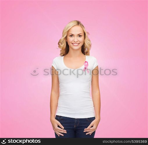 healthcare and medicine concept - woman in blank t-shirt with pink breast cancer awareness ribbon