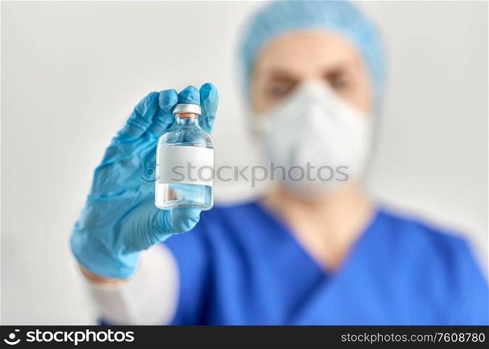 healthcare and pandemic concept - close up of doctor&rsquo;s hand with bottle of medicine or vaccine. close up of doctor&rsquo;s hand with bottle of medicine
