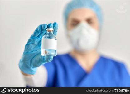 healthcare and pandemic concept - close up of doctor&rsquo;s hand with bottle of medicine or vaccine. close up of doctor&rsquo;s hand with bottle of medicine