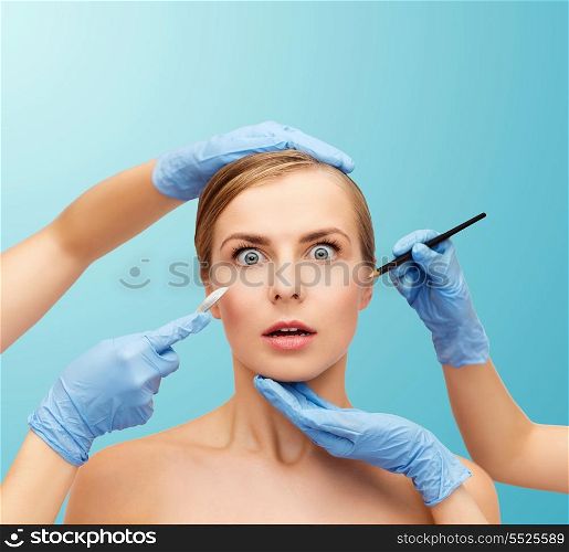 healthcare, beauty and medicine concept - beautiful woman face and beautician hands with pencil and scalpel