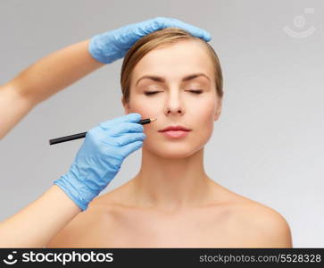 healthcare, beauty and medicine concept - beautiful woman face with closed eyes and beautician hands with pencil