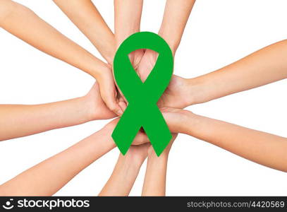 healthcare, charity, people and medicine concept - close up of hands with green organ transplant awareness ribbon over white background