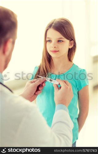 healthcare, child and medicine concept - male doctor with child measuring temperature in hospital