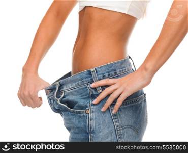 healthcare, diet and fitness concept - close up of female showing big jeans