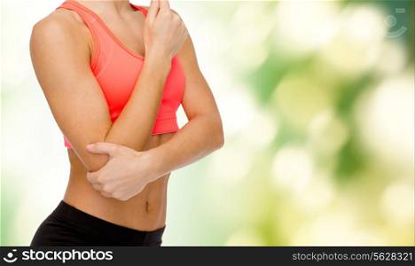 healthcare, fitness and medicine concept - sporty woman with pain in elbow