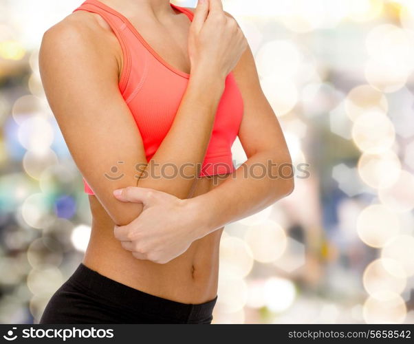 healthcare, fitness and medicine concept - sporty woman with pain in elbow