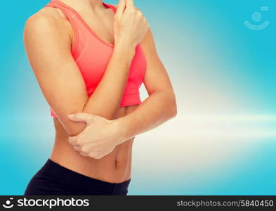 healthcare, fitness and medicine concept - sporty woman with pain in elbow