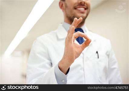 healthcare, gesture, people and medicine concept - close up of happy male doctor at hospital showing ok hand sign