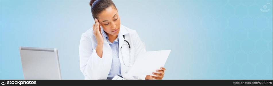 healthcare, medical and diagnosis concept - african female doctor with laptop pc computer looking at medical report over blue background