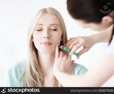 healthcare, medical and plastic surgery - beautician with patient doing botox injection in hospital