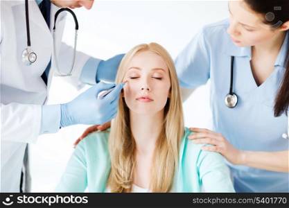 healthcare, medical and plastic surgery concept - plastic surgeon and nurse with patient in hospital