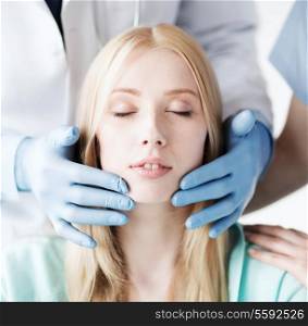 healthcare, medical and plastic surgery concept - plastic surgeon or doctor with patient