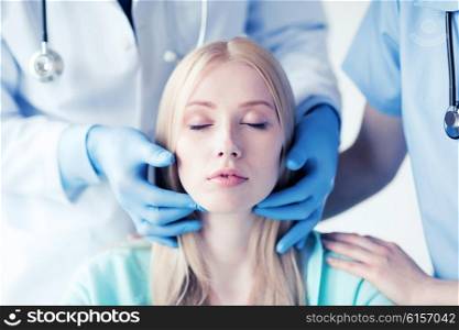 healthcare, medical and plastic surgery concept - plastic surgeon or doctor with patient