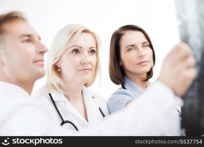 healthcare, medical and radiology concept - doctors looking at x-ray