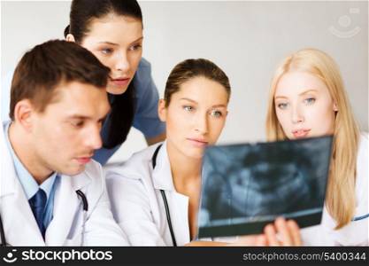 healthcare, medical and radiology concept - group of doctors looking at x-ray
