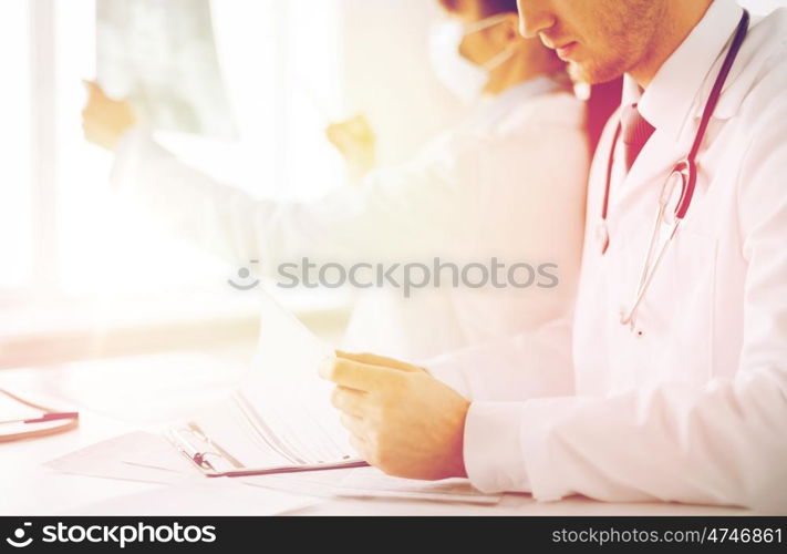 healthcare, medical and radiology concept - two doctors looking at x-ray