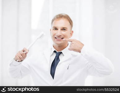 healthcare, medical and stomatology - dentist with toothbrush in hospital