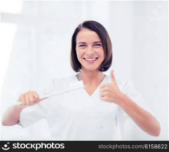 healthcare, medical and stomatology - dentist with toothbrush in hospital