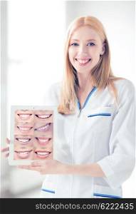 healthcare, medical and stomatology - female doctor with tablet pc and smiles