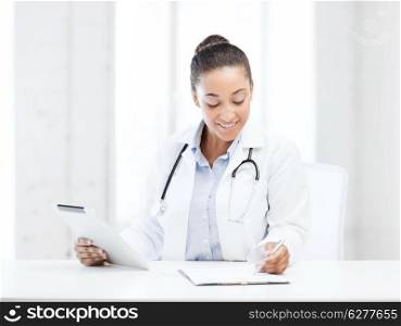 healthcare, medical and technology concept - african female doctor with tablet pc writing prescription
